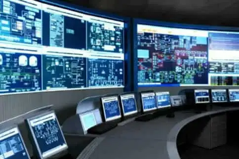 A control room with monitors and computers.
